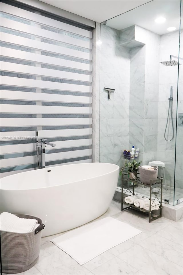 bathroom featuring separate shower and tub