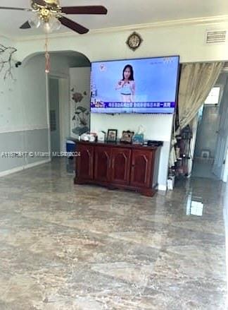 living room featuring crown molding and ceiling fan