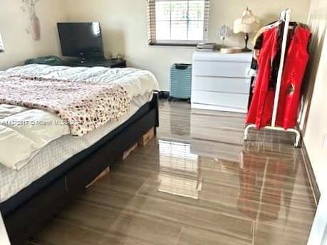 bedroom with wood-type flooring