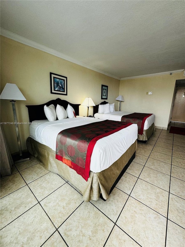 bedroom with ornamental molding, a textured ceiling, and light tile patterned floors