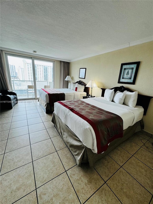 bedroom featuring ornamental molding, a textured ceiling, access to exterior, and light tile patterned flooring