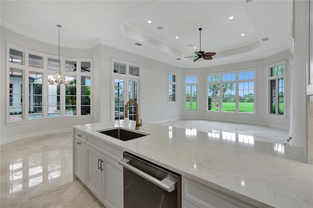 kitchen with white cabinetry, dishwasher, light stone countertops, sink, and decorative light fixtures