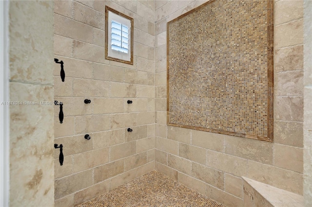 bathroom with a tile shower