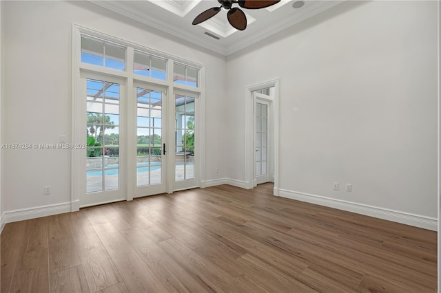 unfurnished room featuring hardwood / wood-style floors, ceiling fan, and ornamental molding