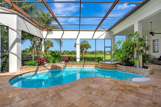 view of pool with a patio, ceiling fan, an in ground hot tub, and glass enclosure