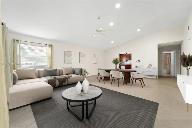 living room with ceiling fan, light tile patterned floors, and vaulted ceiling