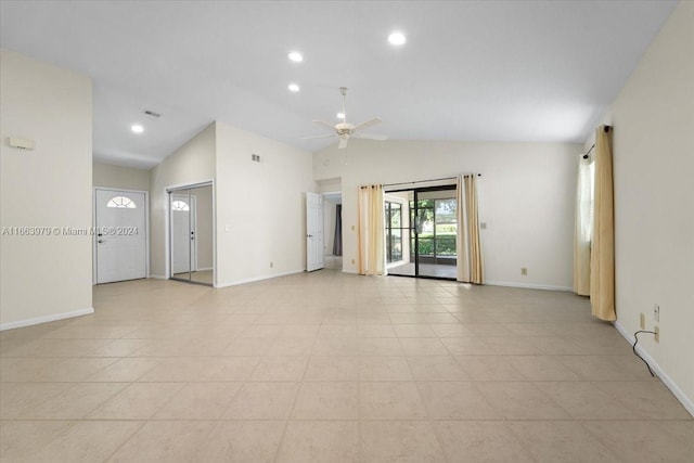 empty room with light tile patterned floors, high vaulted ceiling, and ceiling fan