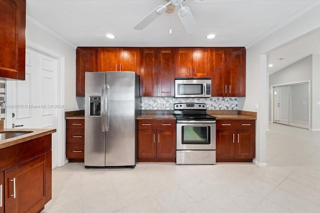 kitchen featuring backsplash, crown molding, ceiling fan, light tile patterned floors, and stainless steel appliances