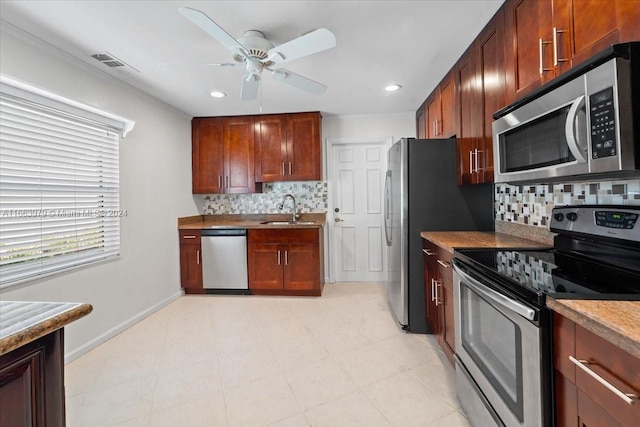 kitchen featuring backsplash, ceiling fan, sink, and appliances with stainless steel finishes