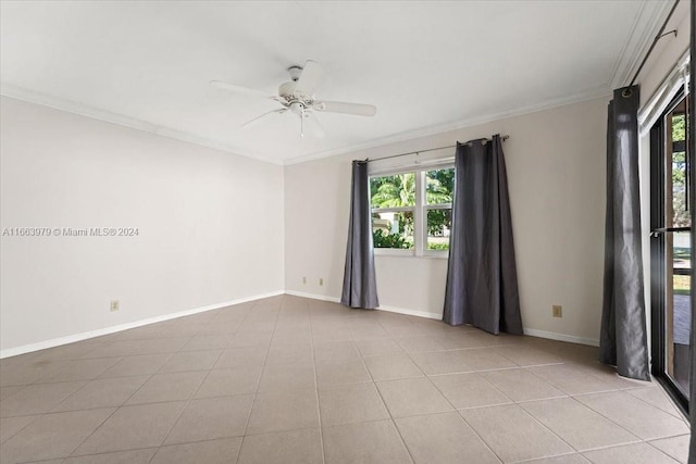 tiled spare room with crown molding, ceiling fan, and a healthy amount of sunlight