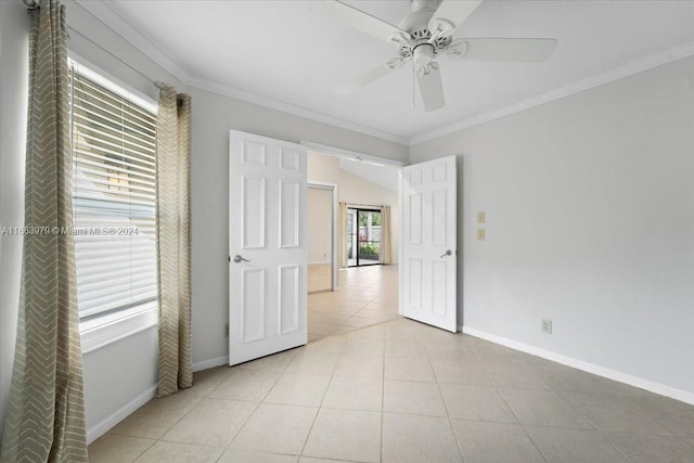 unfurnished bedroom featuring ceiling fan, crown molding, and light tile patterned floors