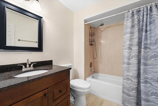 full bathroom with hardwood / wood-style floors, vanity, toilet, and shower / tub combo with curtain