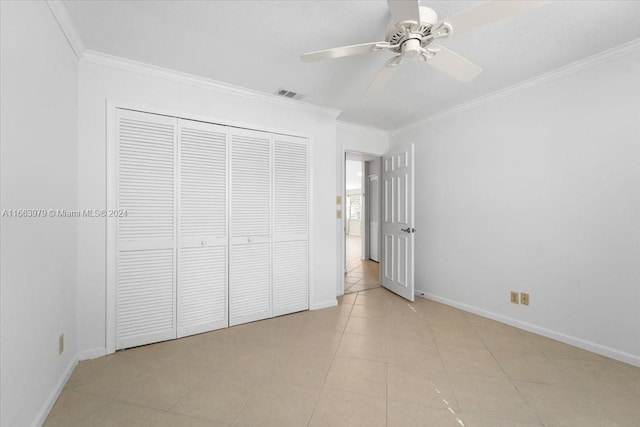 unfurnished bedroom with a closet, ceiling fan, crown molding, and light tile patterned flooring