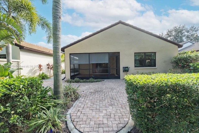 rear view of property with a sunroom