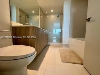 bathroom featuring vanity, tile patterned floors, and an enclosed shower