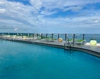 view of pool featuring a water view