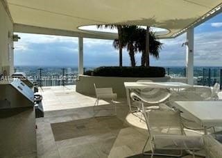 view of patio / terrace with a bar and an outdoor kitchen