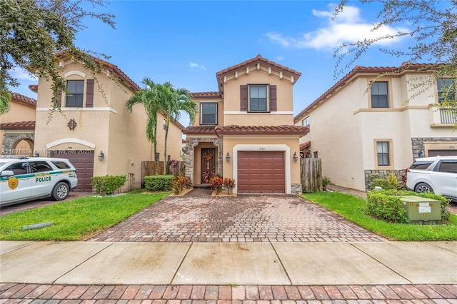 mediterranean / spanish-style home featuring a front yard and a garage