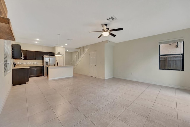 unfurnished living room featuring ceiling fan and light tile patterned flooring