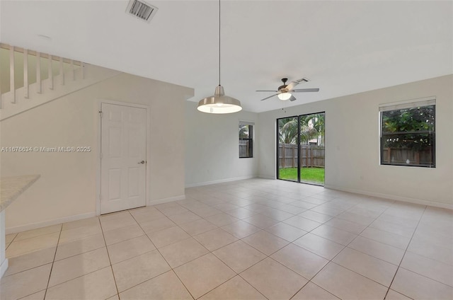 empty room featuring ceiling fan and light tile patterned flooring