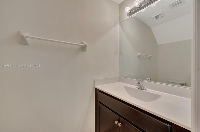 bathroom featuring toilet and vanity