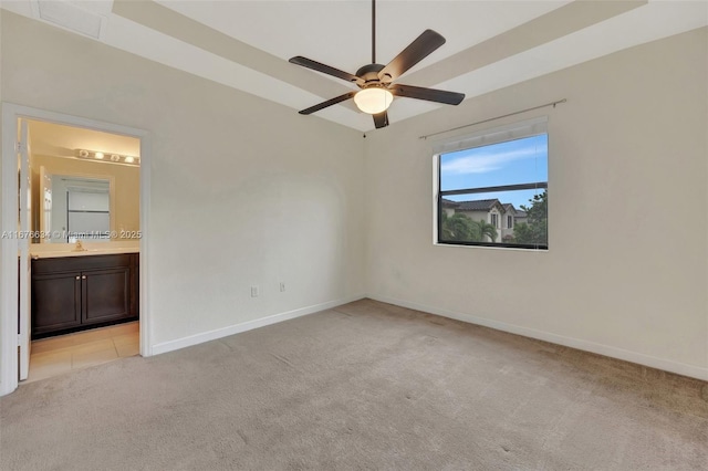 empty room with light carpet, ceiling fan, and sink