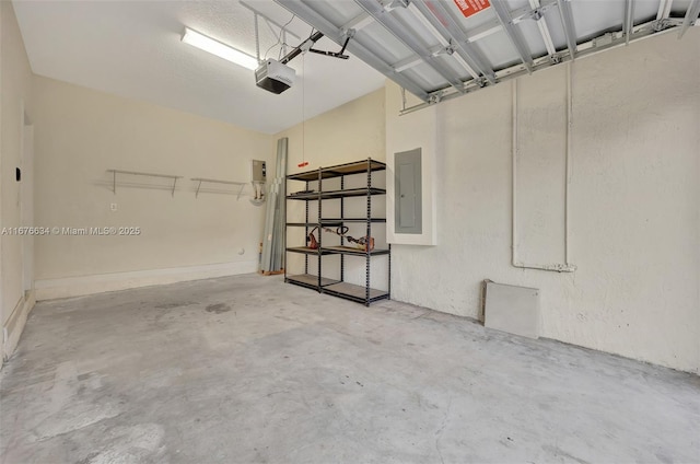 garage with a garage door opener and electric panel