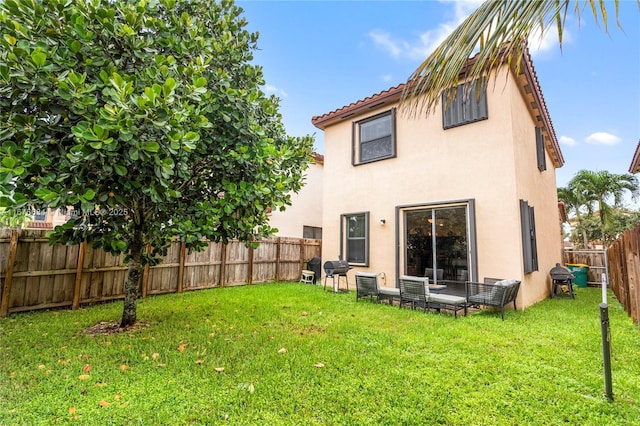 rear view of property featuring a yard