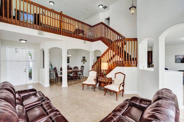 tiled living room with a high ceiling