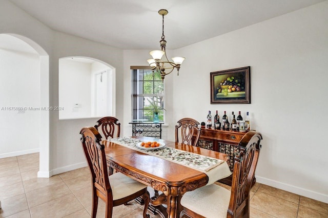 dining room featuring a notable chandelier and light tile patterned floors