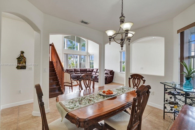 dining area featuring an inviting chandelier and light tile patterned floors