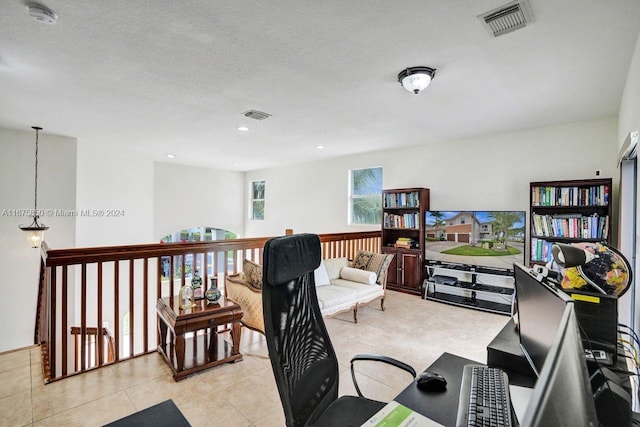 tiled home office with a textured ceiling