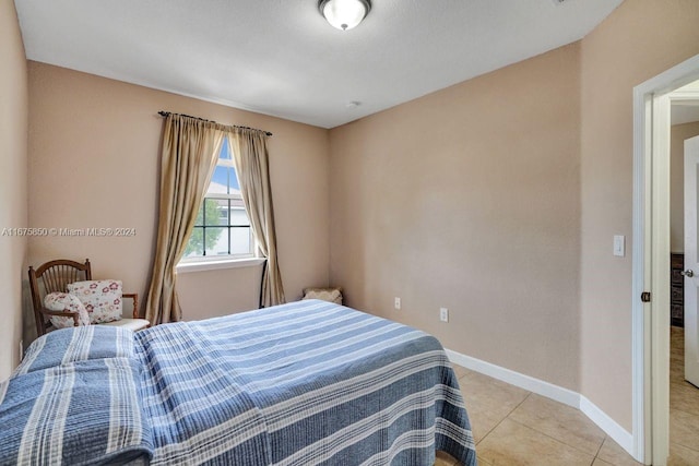 bedroom featuring light tile patterned flooring