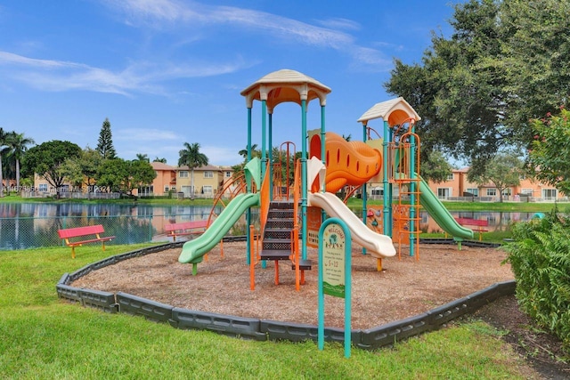 view of play area featuring a yard and a water view