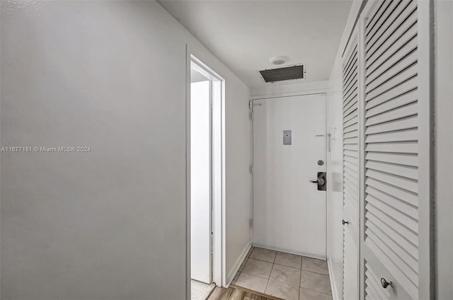 corridor with light tile patterned floors