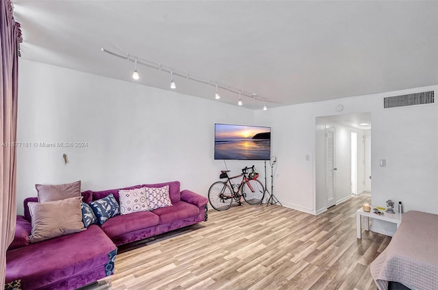 living room with track lighting and light wood-type flooring