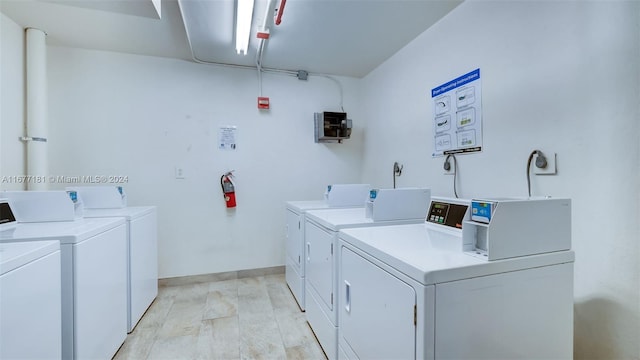 washroom featuring washer and clothes dryer and light wood-type flooring