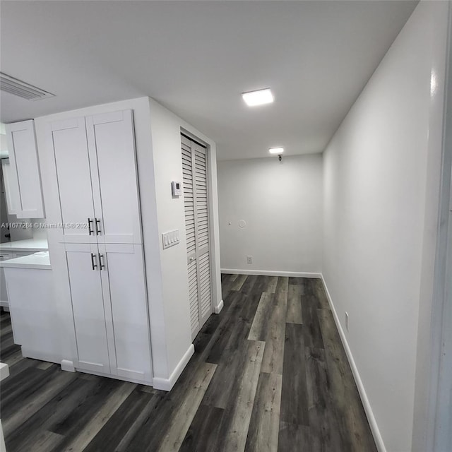 corridor featuring dark hardwood / wood-style floors