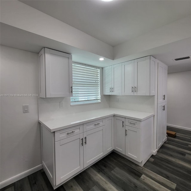 kitchen featuring white cabinetry and dark hardwood / wood-style flooring