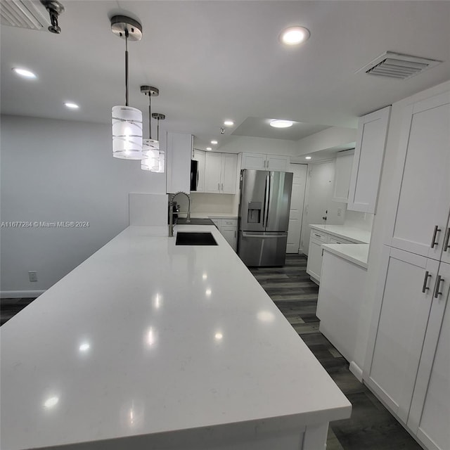 kitchen featuring sink, stainless steel fridge with ice dispenser, dark wood-type flooring, and white cabinetry