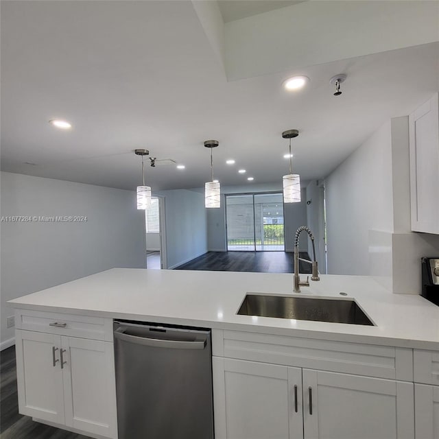 kitchen featuring white cabinetry, stainless steel dishwasher, sink, and a wealth of natural light