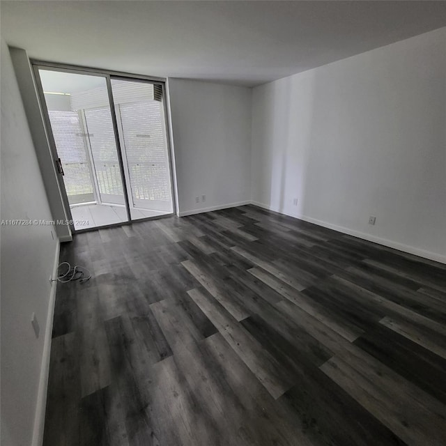 empty room with dark hardwood / wood-style floors