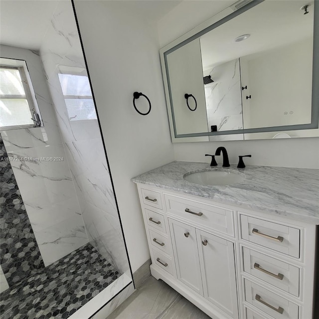 bathroom with vanity and tiled shower