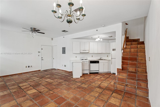 kitchen with white appliances, sink, ceiling fan with notable chandelier, white cabinetry, and pendant lighting