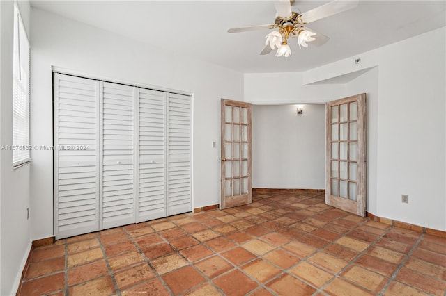 unfurnished bedroom featuring a closet, french doors, and ceiling fan