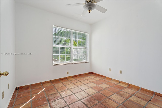 unfurnished room featuring ceiling fan and a wealth of natural light