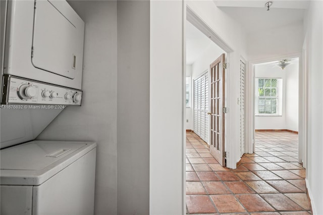 laundry room with stacked washer / dryer and ceiling fan