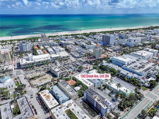 birds eye view of property with a view of the beach and a water view