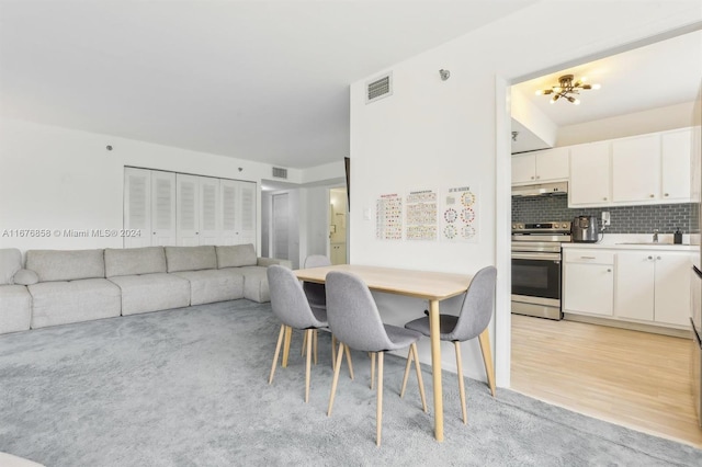 dining room with light hardwood / wood-style floors and sink