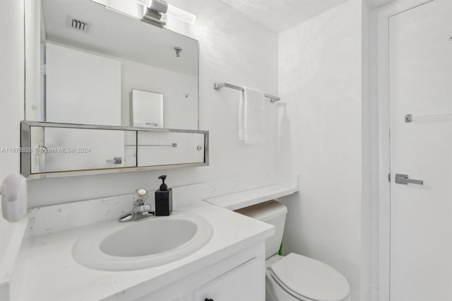 bathroom with toilet and vanity